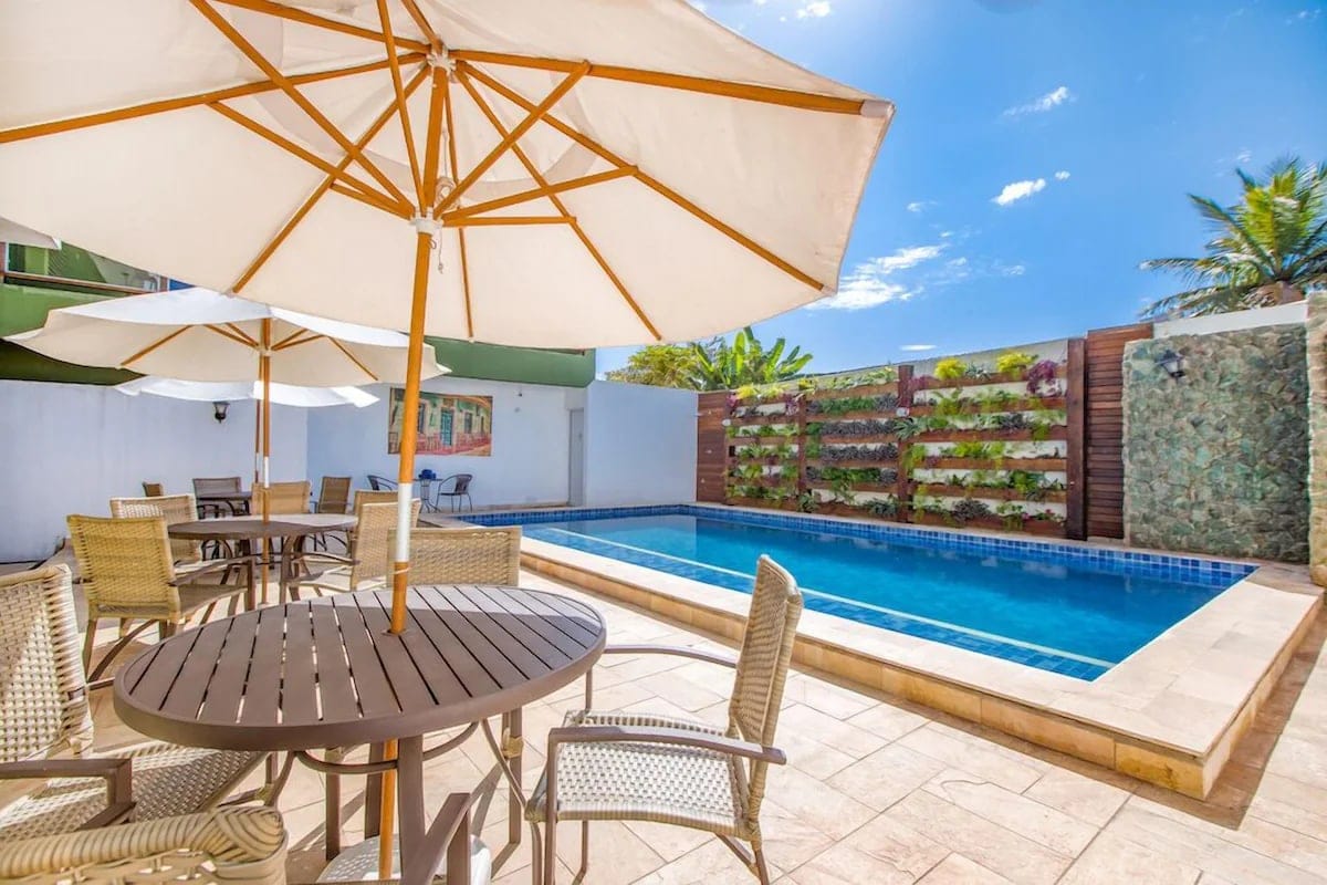 Piscina com mesas e guarda-sóis